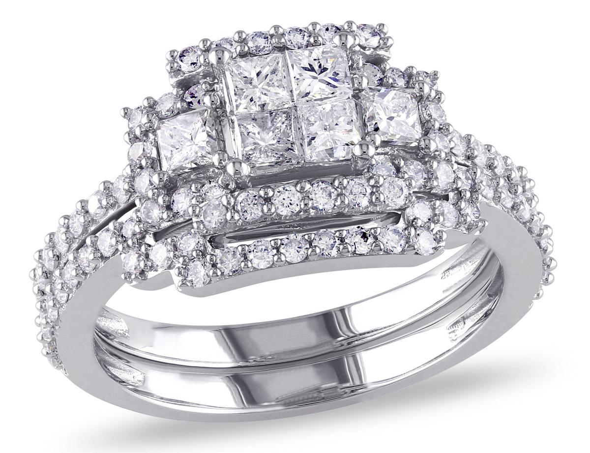 This sophisticated engagement ring features invisibly-set princess-cut white diamonds at its center which give the illusion of a larger center stone within a 3-stone setting. This beautiful ring set is crafted of fine 14-karat white gold and is enhanced with a frame of round diamonds.